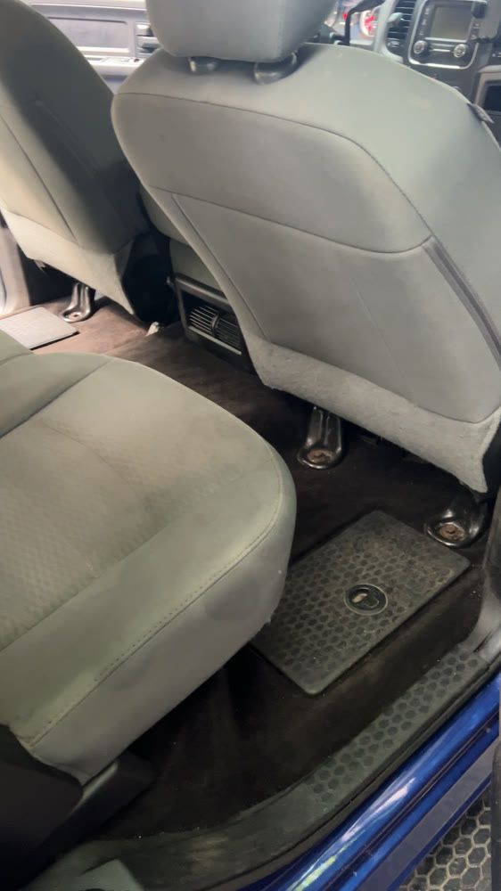 The same cream interior after cleaning, seats and floor reset