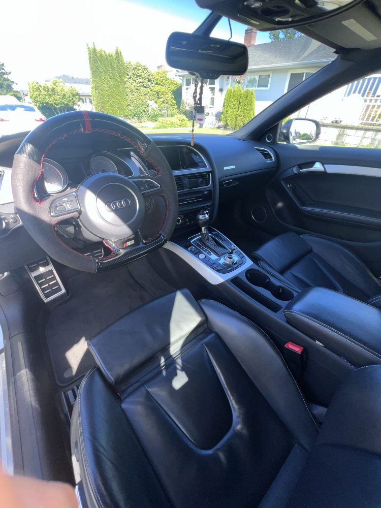 An Audi interior after cleaning — steering wheel and front seats