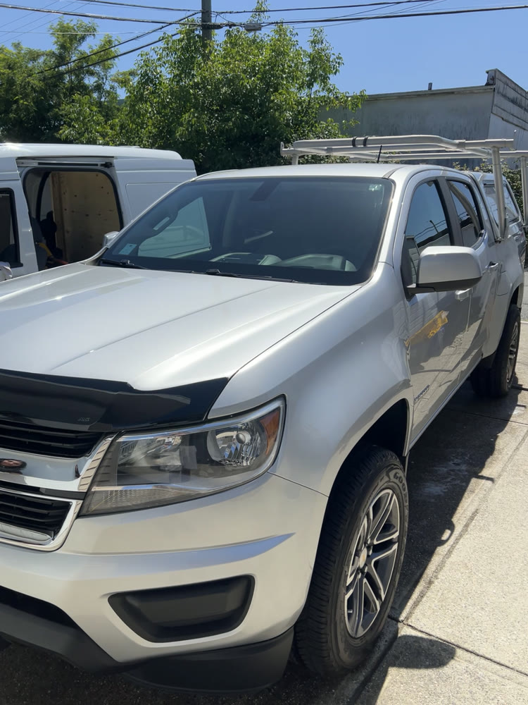 A silver Chevrolet Colorado pickup after an exterior wash